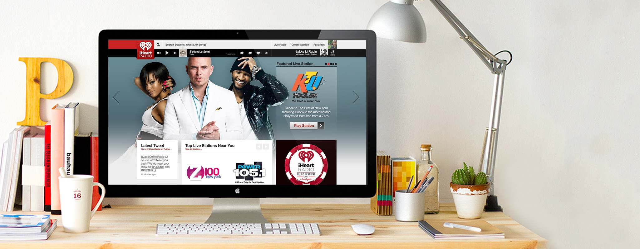 Hero image: The redesign of the iHeart Website on a Mac display on a desk.